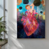 A surreal painting featuring a large glowing anatomical heart in vivid reds, purples, and oranges at the center. A smiling woman with red hair emerges from behind the heart, raising one arm joyfully. Around her float dark spherical orbs a